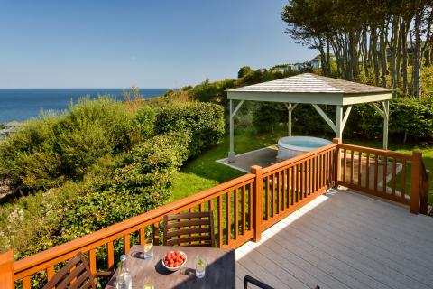 lodge with hot tub and sea views in dabbled sunlight