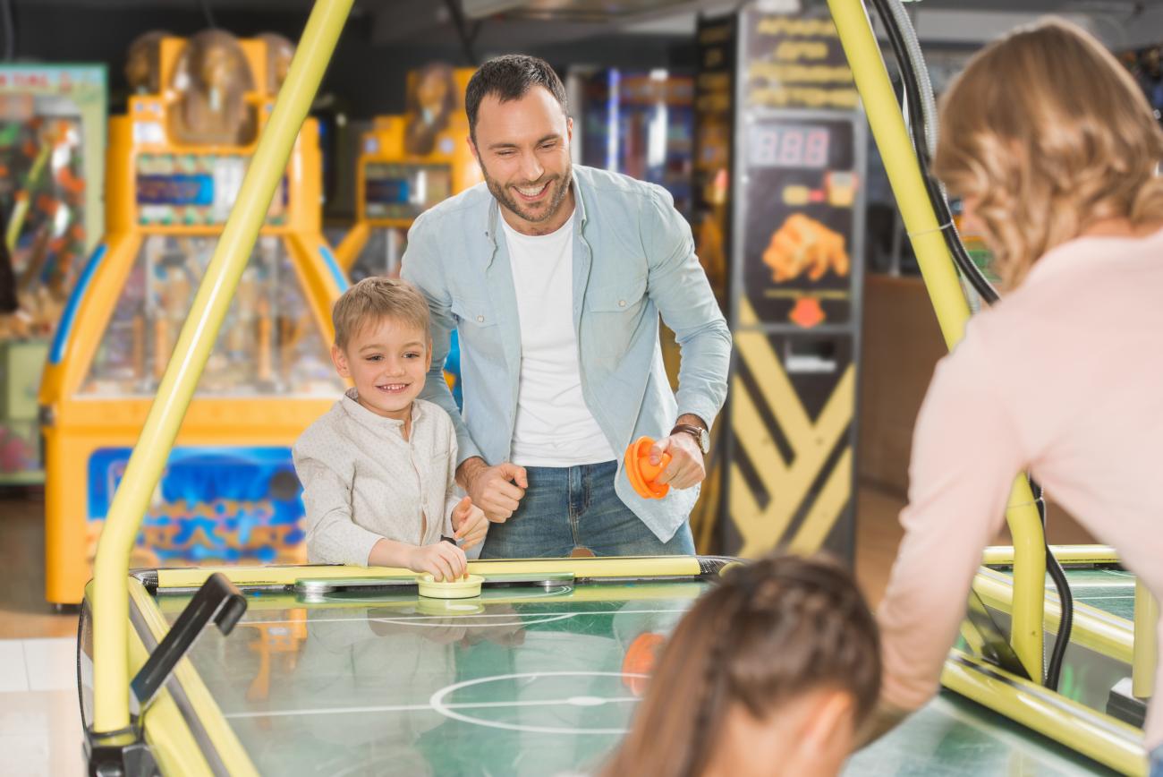 Family having fun in the Smugglers Cove Games Room at Elie Holiday Park