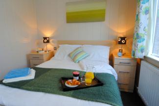 Lodge master bedroom with breakfast tray on bed