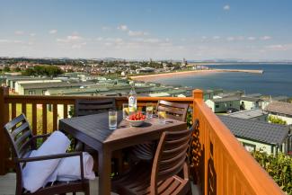 Open bottle of wine on patio table on sunny veranda