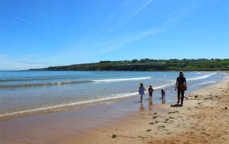 family walking on the beach at East Sands