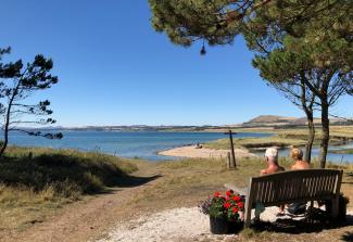 Mature couple seating on bench enjoying the view of Largo Bay